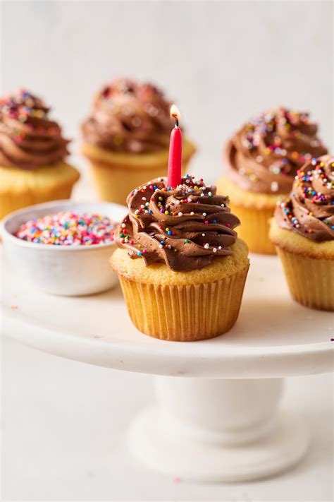 yellow-cupcakes-with-chocolate-frosting-baker-by image