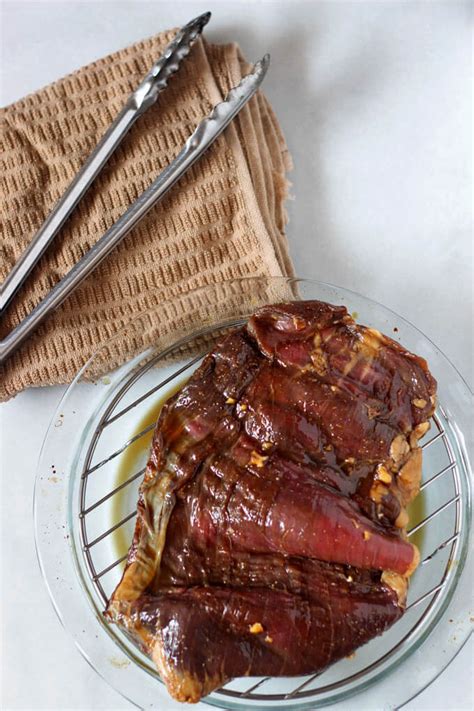 beef-tapa-inspired-marinated-flank-steak-breaking image