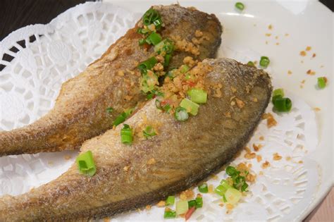 korean-fried-whole-fish-recipe-with-yellow-croaker-the-spruce image