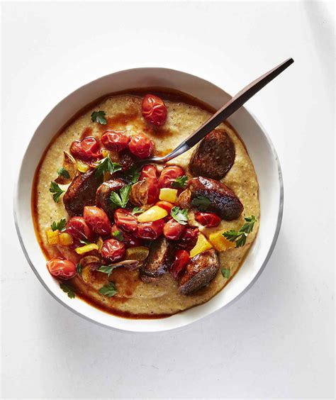 old-bay-cheddar-grits-with-andouille-and-tomatoes image
