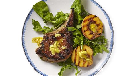 curry-butter-glazed-pork-chops-and-peaches image