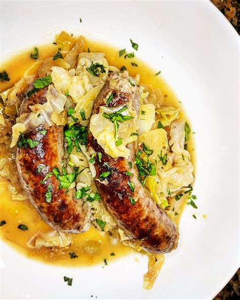 beer-braised-brats-with-cabbage-apples-and-onions image