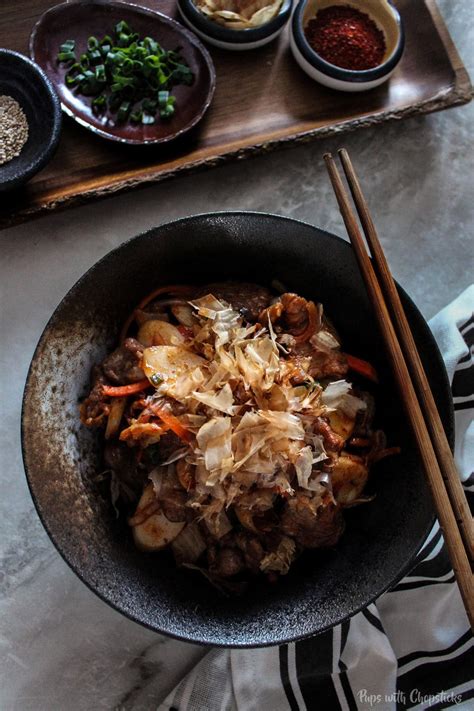 stir-fried-kimchi-rice-cakes-pups-with-chopsticks image