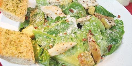 cajun-chicken-caesar-salad-with-garlic-baguette-food image