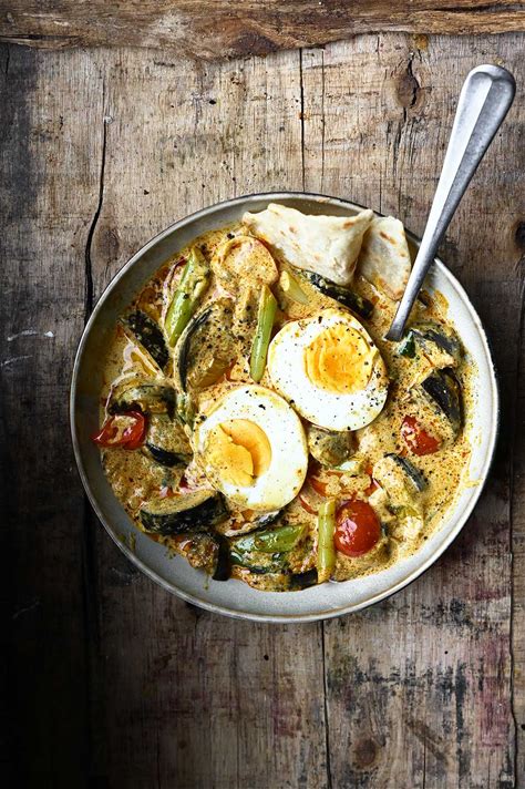 coconut-egg-curry-with-eggplant-serving-dumplings image